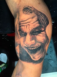the joker tattoo on a man's arm